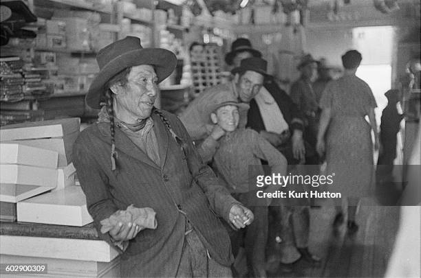 Native Americans of the Enoch Cree Nation, in the local store on one of the Stony Plain 135 reserves in Alberta, Canada, 1939. Original Publication:...