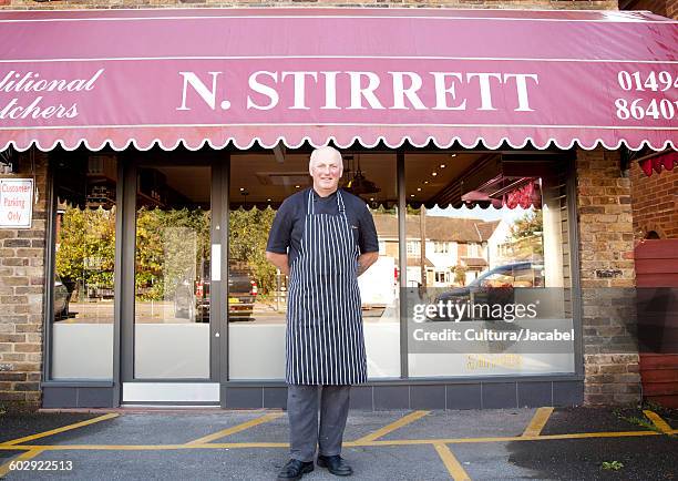 portrait of butcher outside butchers shop - butcher portrait imagens e fotografias de stock