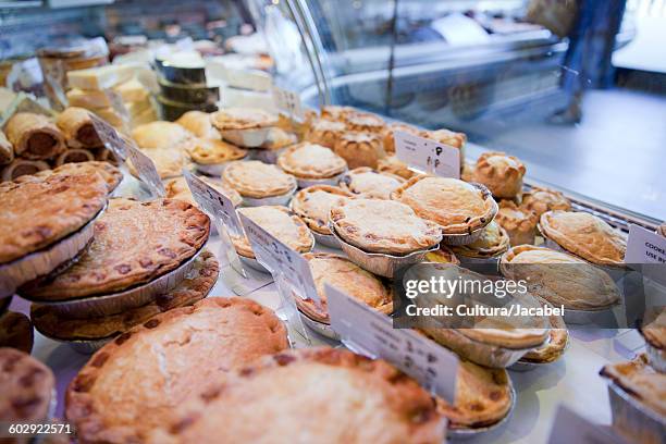 variety of fresh meat pies in refrigerator at butchers shop - meat pie stock pictures, royalty-free photos & images