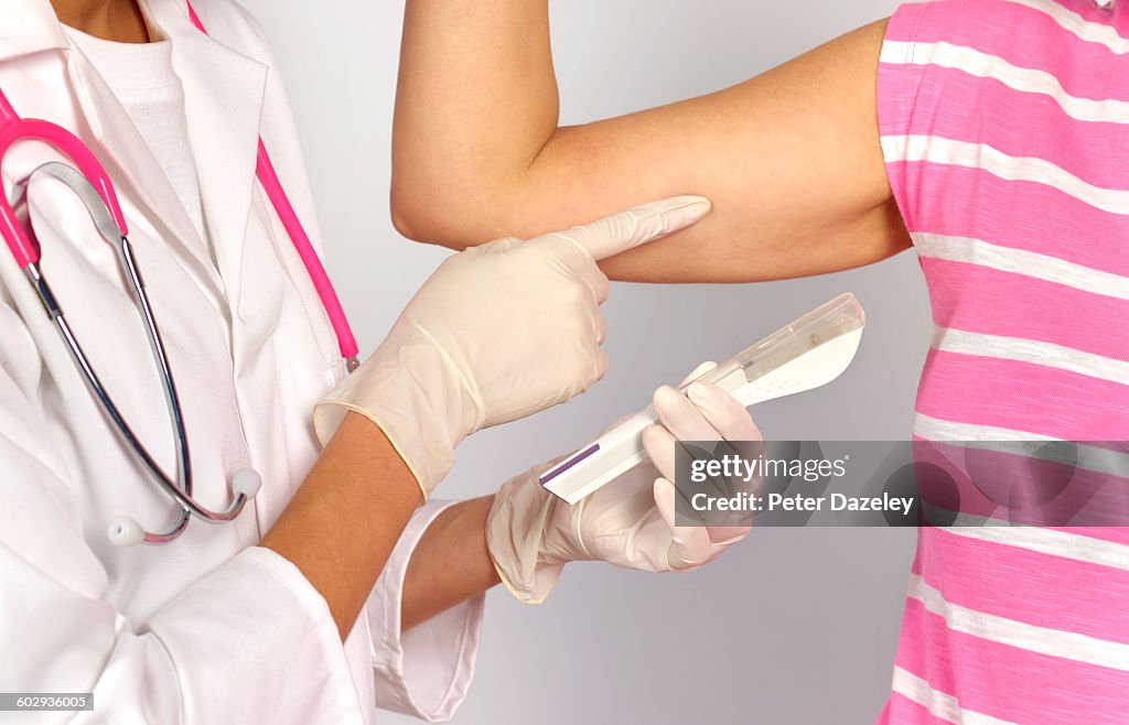 Doctor with contraceptive implant