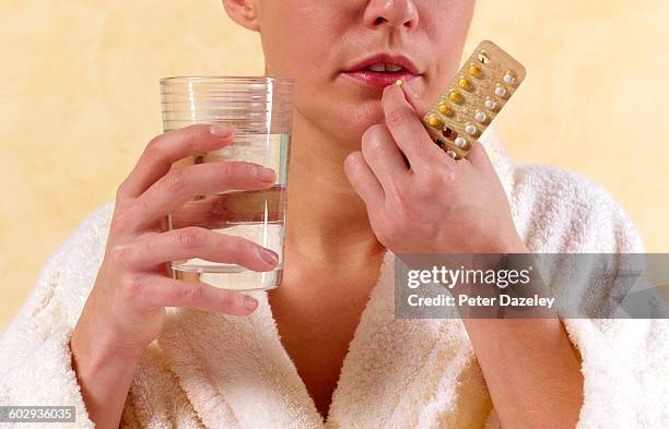 latin american woman with birth control pill - birth control pills fotografías e imágenes de stock