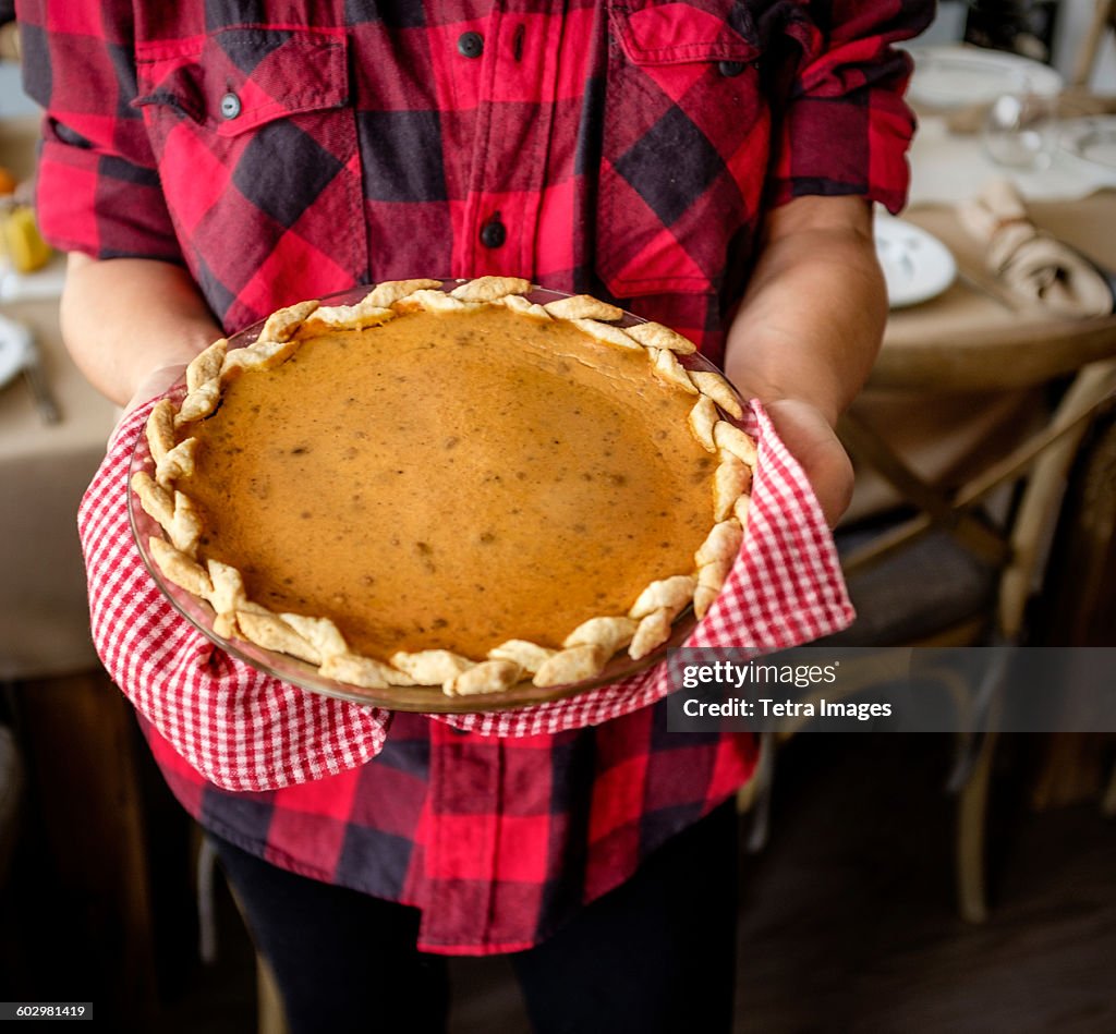 USA, New York State, New York City, Woman holding baked pumpkin pie for Thanksgiving
