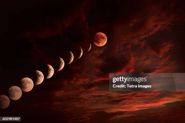 moon on cloudy night sky - total lunar eclipse stock pictures, royalty-free photos & images