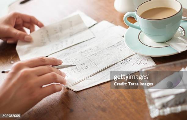 woman writing on napkins - napkin stock pictures, royalty-free photos & images