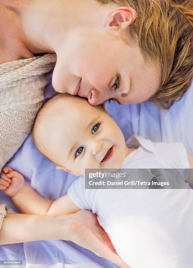USA, Maine, Camden, Mother lying down with baby boy (6-11 months)