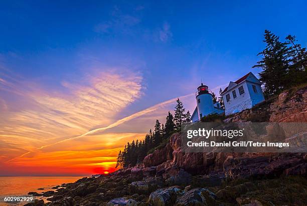 usa, maine, mount desert island, acadia national park, tremont, bass harbor head lighthouse at sunset - sunset with jet contrails stock pictures, royalty-free photos & images