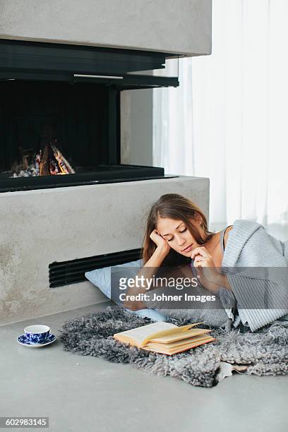 woman reading book - sheepskin stock pictures, royalty-free photos & images