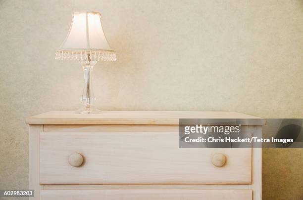 electric lamp on wooden dresser - chest imagens e fotografias de stock
