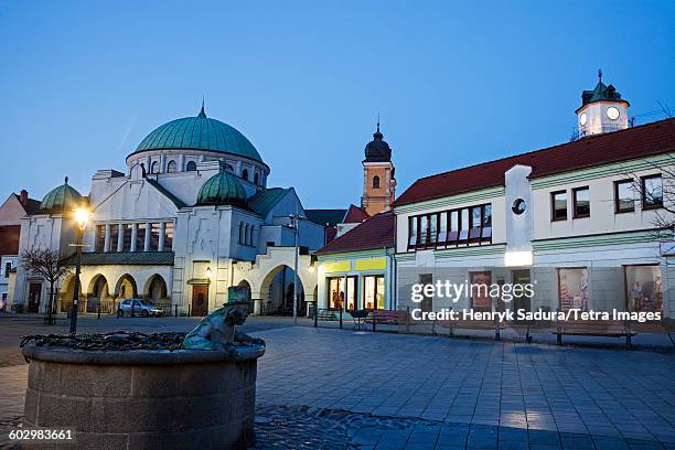 slovakia, trencin, buildings at town square at dusk - slovakia castle stock pictures, royalty-free photos & images