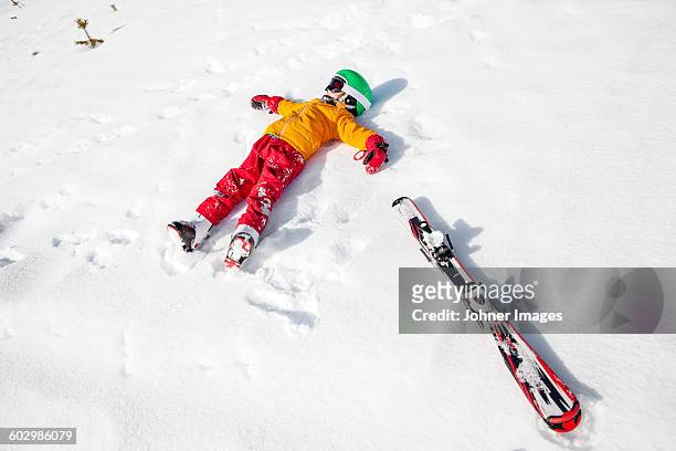 child on snow with snowboard - funny snow skiing stock pictures, royalty-free photos & images