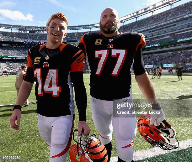 Teammates Andy Dalton and Andrew Whitworth of the Cincinnati Bengals celebrate after a 23-22 victory over the New York Jets during their game at...