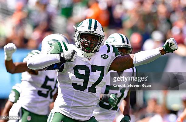 Lawrence Thomas of the New York Jets celebrates after making a tackle on a punt return by the Cincinnati Bengals during the second quarter at MetLife...