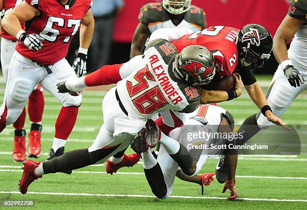 Matt Ryan of the Atlanta Falcons is tackled by Kwon Alexander and Alterraun Verner of the Tampa Bay Buccaneers at the Georgia Dome on September 11,...