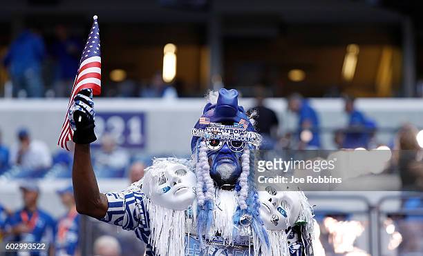 An Indianapolis Colts fan waves an American flag before the start of game between the Indianapolis Colts and the Detroit Lions at Lucas Oil Stadium...