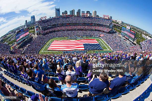 The United States flag covering the field before a game between the Tennessee Titans and the Minnesota Vikings at Nissan Stadium on September 11,...