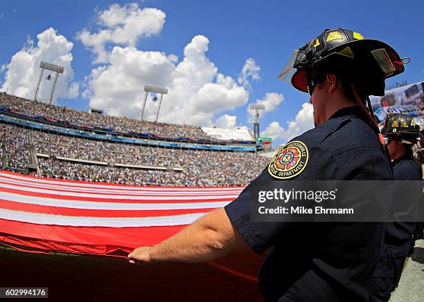 Member of the Jacksonville fire department hold the flag during a game between the Jacksonville Jaguars and the Green Bay Packers at EverBank Field...