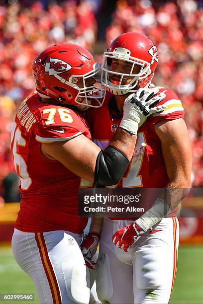 Tight end Travis Kelce of the Kansas City Chiefs is congratulated by teammate Laurent Duvernay-Tardif after his amazing catch during the game tying...