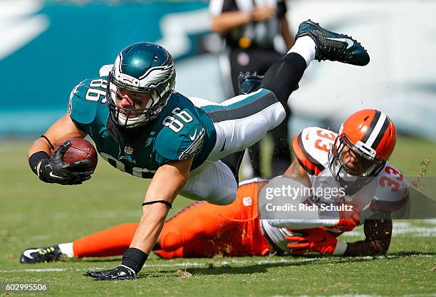 Zach Ertz of the Philadelphia Eagles is tripped up by Jordan Poyer of the Cleveland Browns after making a catch during the third quarter at Lincoln...