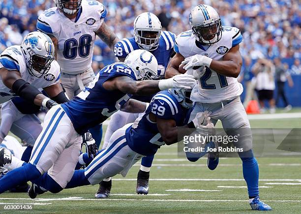 Ameer Abdullah of the Detroit Lions runs past D'Qwell Jackson of the Indianapolis Colts and Mike Adams of the Indianapolis Colts during the second...