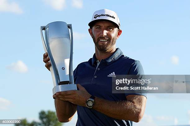 Dustin Johnson poses with the trophy after his three stroke victory at the BMW Championship at Crooked Stick Golf Club on September 11, 2016 in...