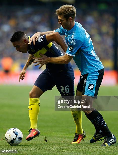 Adrian Centurion of Boca Juniors fights for the ball with Mario Bolatti of Belgrano during a match between Boca Juniors and Belgrano as part of...