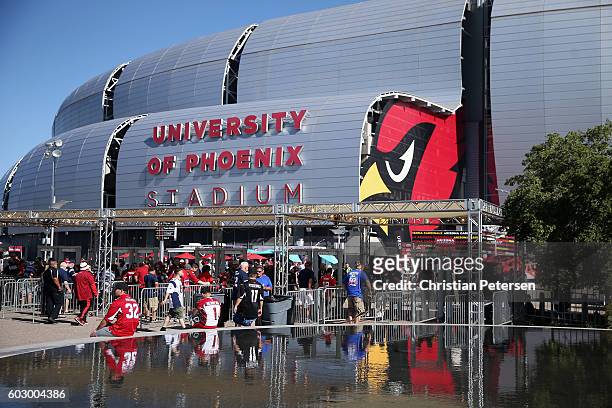 Fans arrive to the NFL game between the Arizona Cardinals and the New England Patriots at the University of Phoenix Stadium on September 11, 2016 in...