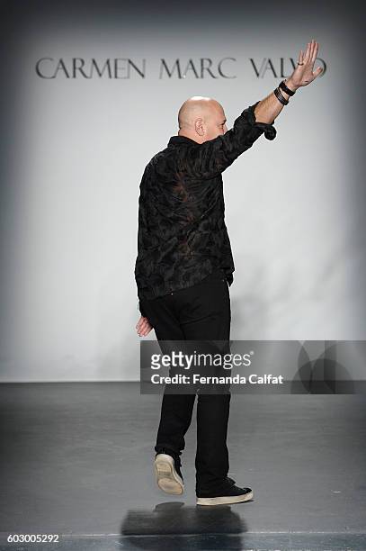 Designer Carmen Marc Valvo poses on the runway at the Carmen Marc Valvo Spring/Summer 2017 Fashion Show during New York Fashion Week at Pier 59...