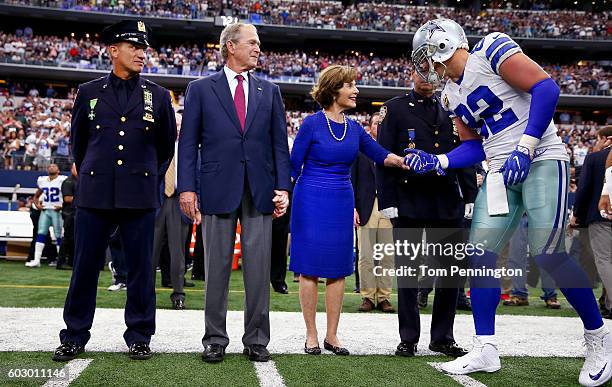 Jason Witten of the Dallas Cowboys greets former First Lady Laura Bush and former U.S. President George W. Bush prior to the game against the New...