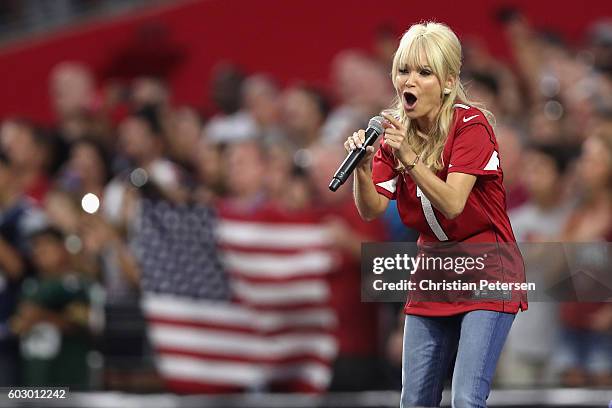 Singer/actress Kristin Chenoweth performs the national anthem before the NFL game between the New England Patriots and the Arizona Cardinals at the...