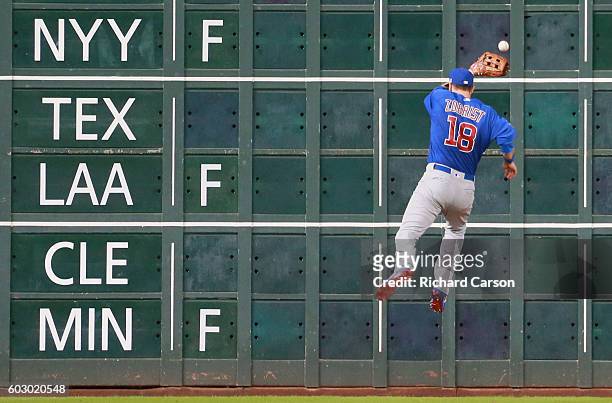 Ben Zobrist of the Chicago Cubs fields a line drive off the score board in center field in the sixth inning against the Houston Astros at Minute Maid...