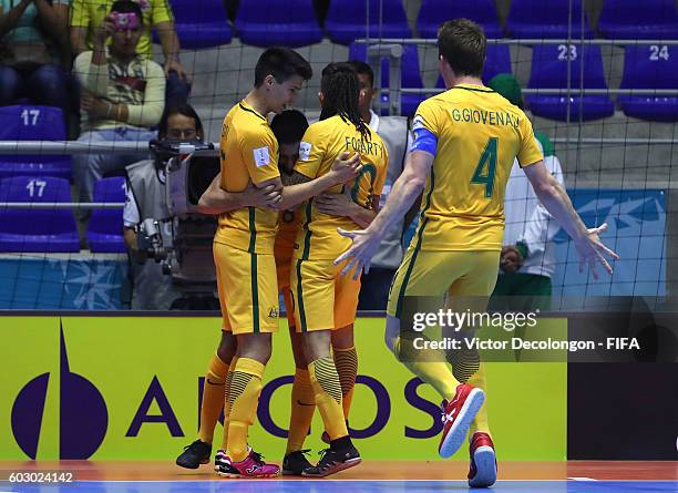 Greg Giovenali of Australia joins teammates Tobias Seeto, Jonathan Barrientos and Daniel Fogarty to celebrate Barrientos' goal during Group D match...