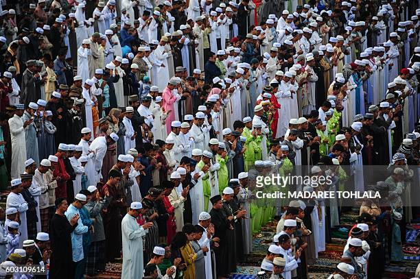 Thai Muslims take part in morning prayers on the day of Eid al-Adha celebrations in Thailand's southern province of Narathiwat on September 12, 2016....