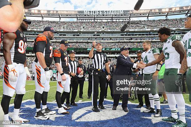 Rudy Guliani shakes hands with Brandon Marshall when he serves as Honorary Captain at the Coin Toss before the New York Jets versus Cincinnati...