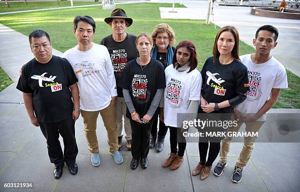 Bai Shuanfu and Jiang Hui , relatives of victims from Malaysia Airlines flight MH370 which disappeared in 2014, pose with US amateur investigator...