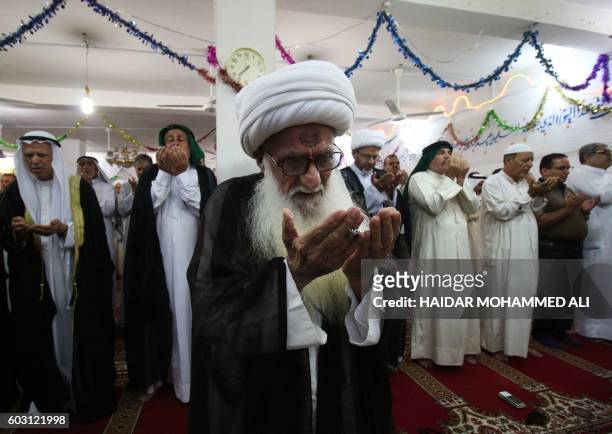 Muslim devotees perform the morning Eid al-Adha prayer at a mosque in the Iraqi city of Basra on September 12, 2016. Muslims across the world...
