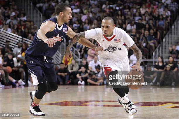 Music artist Chris Brown handles the ball against music artist Kalin White during 2016 Power 106 All Star Celebrity Basketball Game at USC Galen...