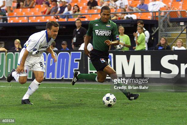 Robin Fraser of the Colorado rapids dribbles against the defense of Chris Brown during the match at Mile High Stadium in Denver, Colo. The game ended...