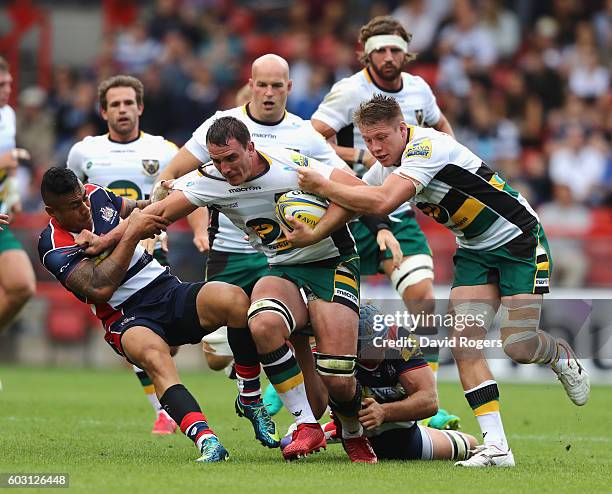 Louis Picamoles of Northampton is held by Tusi Pisi and Olly Robinson during the Aviva Premiership match between Bristol and Northampton Saints at...