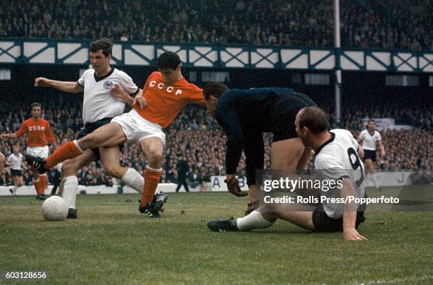 Desperate defending by the Soviet Union to thwart Uwe Seeler and Lothar Emmerich of West Germany during the World Cup semi-final between West Germany...