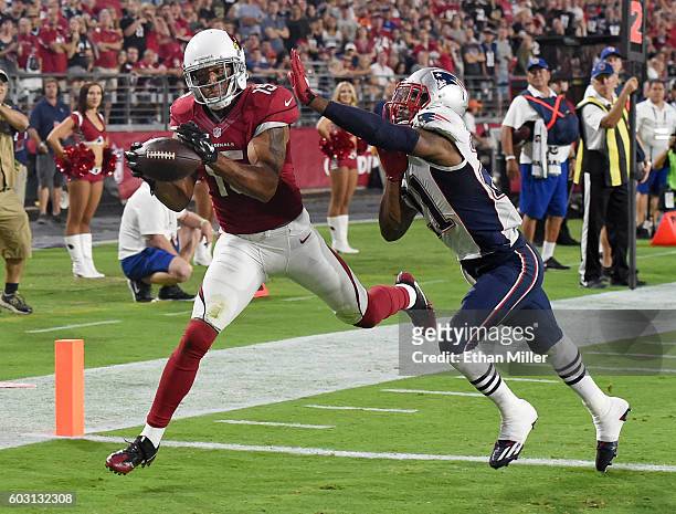 Wide receiver Michael Floyd of the Arizona Cardinals misses a pass in the end zone under pressure from cornerback Malcolm Butler of the New England...
