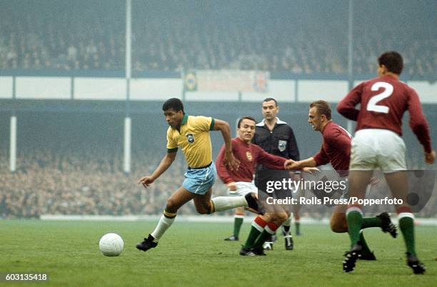 Jairzinho of Brazil moves through the Hungarian defence watched by referee Ken Dagnall during the FIFA World Cup match at Goodison Park in Liverpool,...