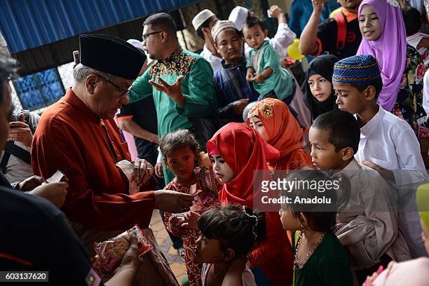 Malaysian Ambassador to Cambodia, Dato' Sri Haji Hasan Malek, give gifts to children outside the prayer hall during Eid-Al-Adha in Phnom Penh,...