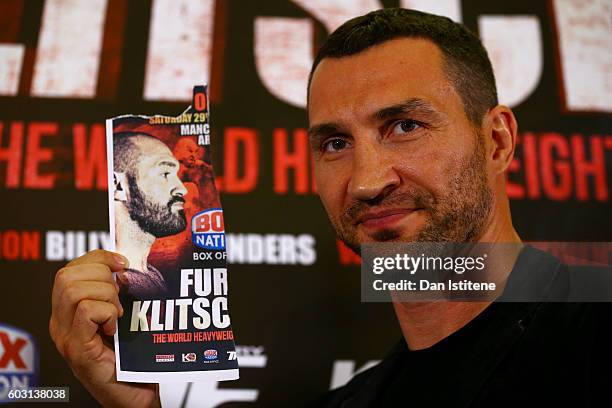 Wladimir Klitschko poses with an image of Tyson Fury after he failed to appear at a press conference ahead of the world heavyweight title rematch...