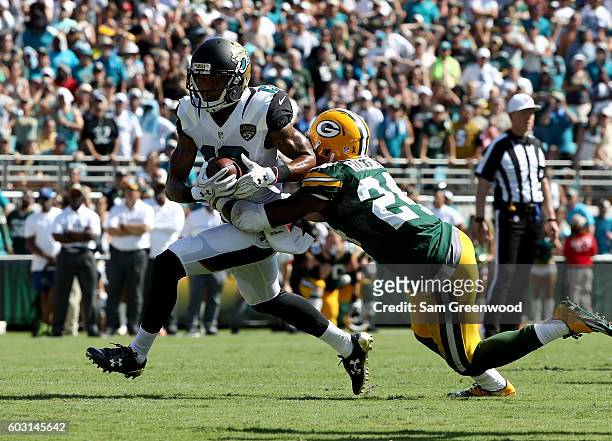 Quinten Rollins of the Green Bay Packers attempts to tackle Rashad Greene of the Jacksonville Jaguars during a game at EverBank Field on September...
