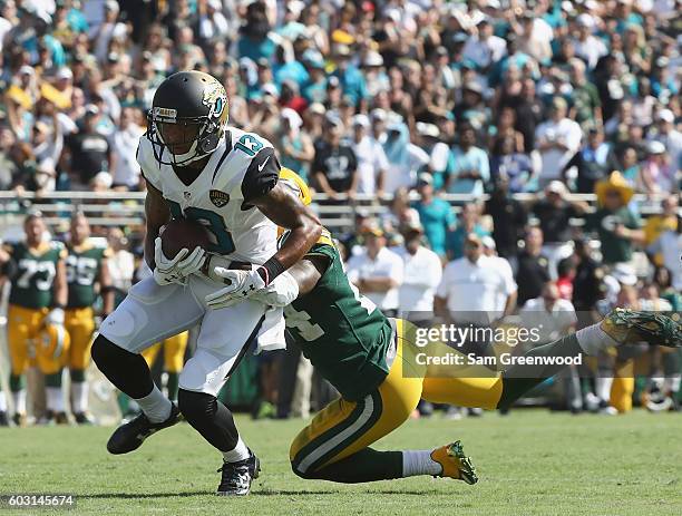 Quinten Rollins of the Green Bay Packers attempts to tackle Rashad Greene of the Jacksonville Jaguars during a game at EverBank Field on September...