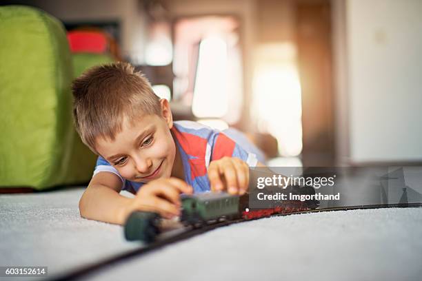 cute little boy playing with miniature train - miniature train stock pictures, royalty-free photos & images