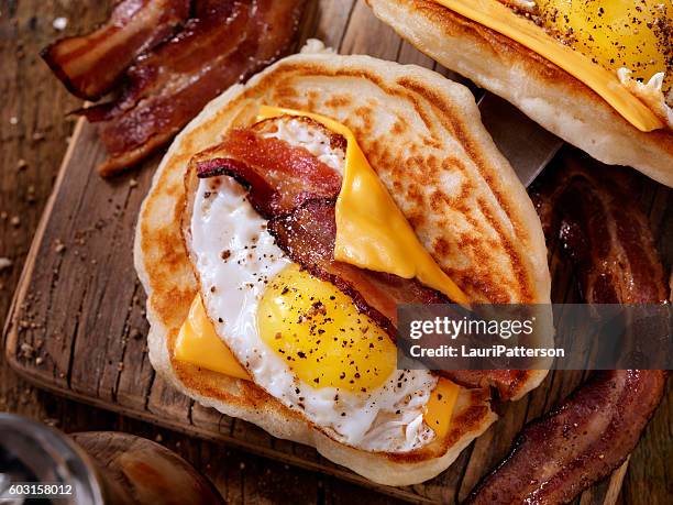 pancake breakfast taco with suny side up eggs, bacon, cheese - filling bildbanksfoton och bilder