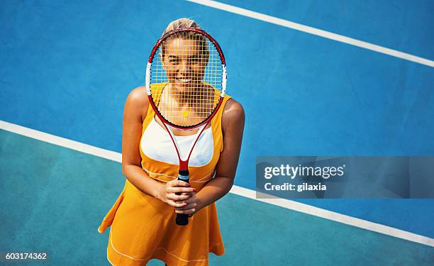 portrait of female tennis player. - blue tennis court stock pictures, royalty-free photos & images