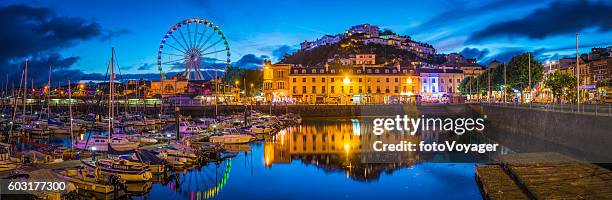 devon torquay harbour marina illuminated at sunset panorama torbay uk - paignton imagens e fotografias de stock