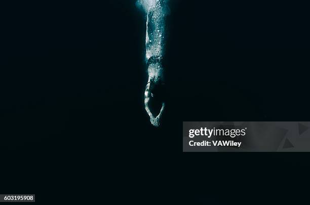 diving into dark water, unknown, future - synchronized swimming stock pictures, royalty-free photos & images